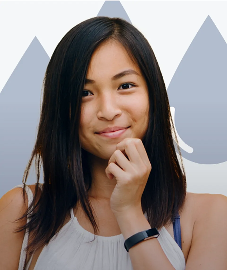 A smiling woman with long dark hair rests her chin on her hand, in front of the brand's blue droplet shapes
